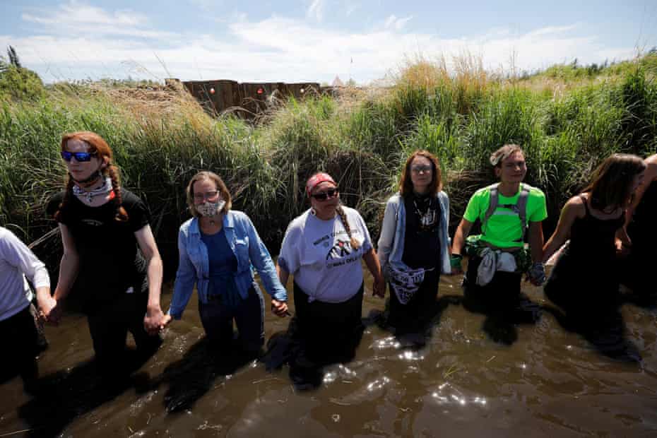 Indigenous leaders and activists participate in a prayer at the Mississippi headwaters on the third day of a protest of the Line 3 pipeline.