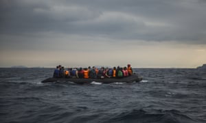 Refugees and migrants onboard a dinghy approach the Greek island of Lesbos after crossing the Aegean sea from Turkey.