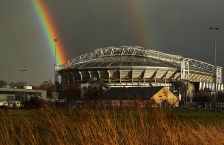 A view outside the stadium as a rainbow is seen in the distance.