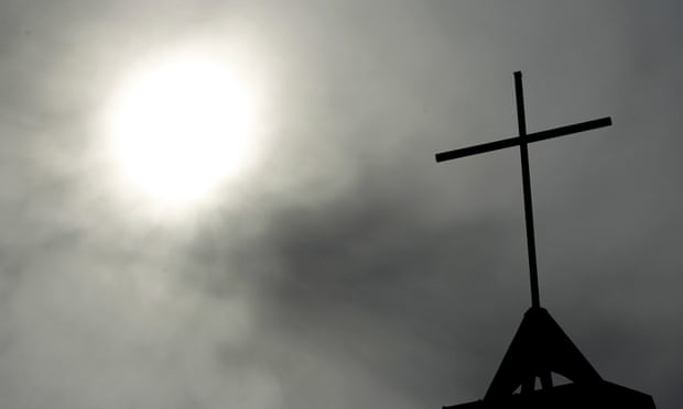 In this file photo a cross sits on top of a church in Berlin, Germany