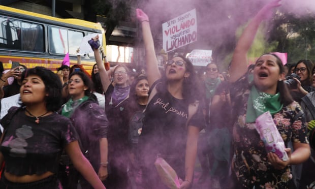 Women toss pink glitter during a protest march in Mexico City on Friday 16 August.