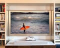 A samsung the frame tv mounted on a wall and displaying artwork