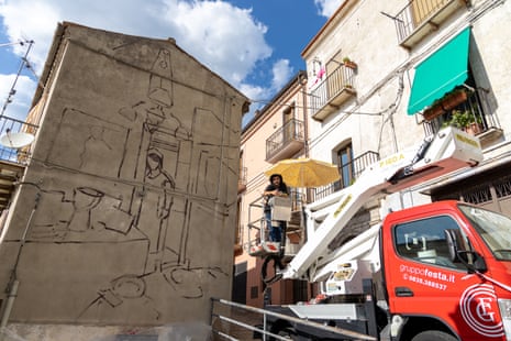 Street artist Mohamed L’Ghacham as the mural starts to take shape on a wall in San Chirico Raparo.