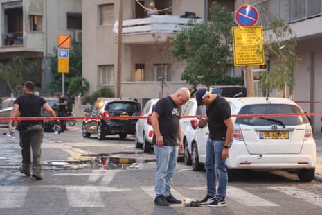 Members of the Israeli security forces are seen at a cordoned-off area where an explosion took place in Tel Aviv