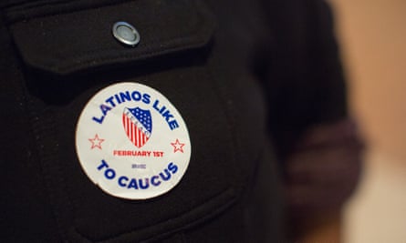 A meat processing facility employee wears a political sticker during a meeting on Sunday in Marshalltown, Iowa.