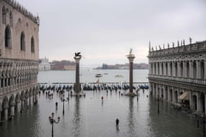 The flooded Piazza San Marco, the Doge’s Palace (left), the Lion of St. Mark winged bronze statue and the Venetian lagoon after the exceptional overnight high tide water level