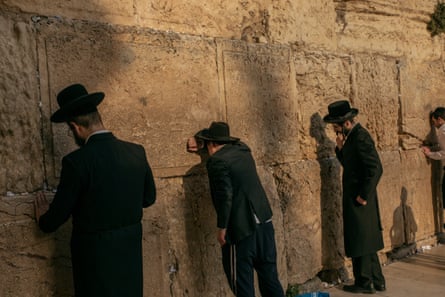 Ultra-Orthodox Jewish men pray at the men’s section of the Western Wall