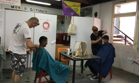 Iranian refugees get their hair cut at the Miksalište refugee centre in central Belgrade.