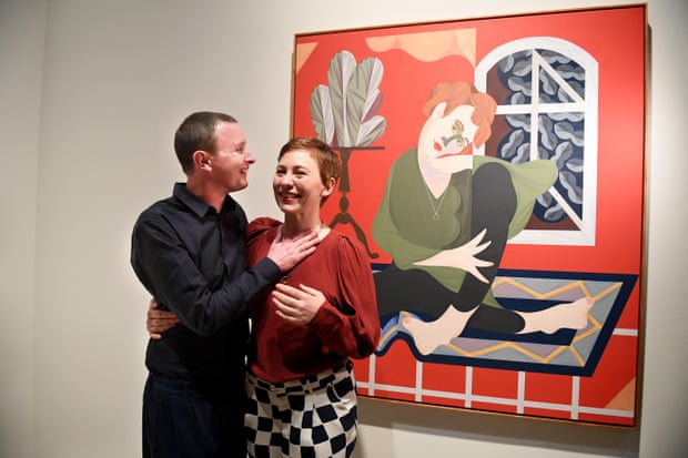 Archibald 2017 winner Mitch Cairns with his partner Agatha Gothe-Snape and the painting that bears her name.