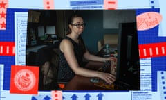 a woman looks at computer screens