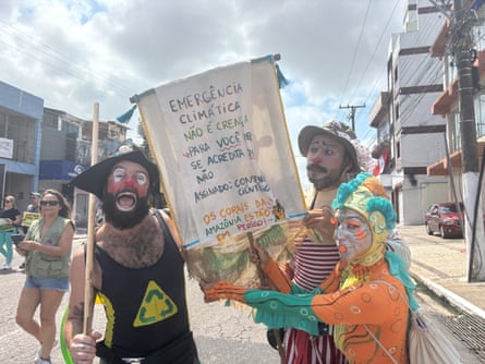 Demonstrators with a sign calling for action on the climate emergency
