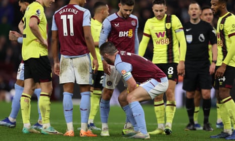 Crouching midfielder, hidden penalty spot: John McGinn protects the penalty spot after a penalty is given to Villa late on.