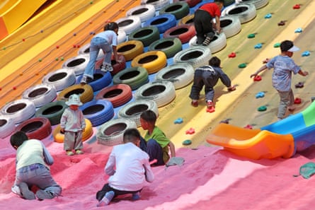 Primary and secondary school students play with colourful tyres
