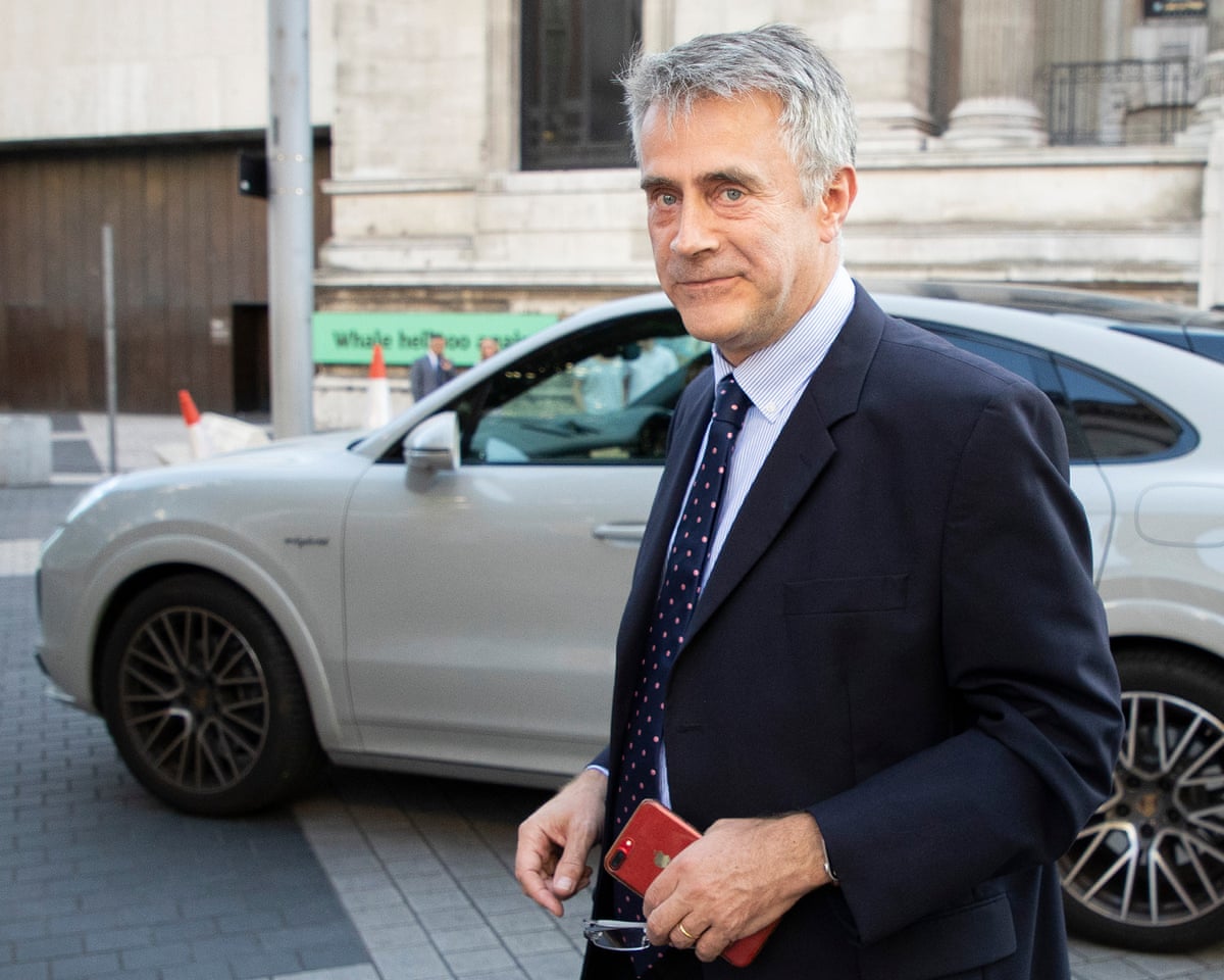 Harborne, wearing a suit, in the street in London arriving at an event