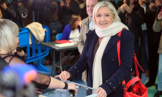 Front National leader Marine Le Pen prepares to vote in the first round of regional elections.