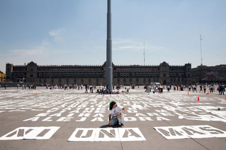 Women paint the names of victims of femicide in front of Mexico’s national palace before a march on 8 March 2020.