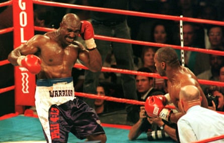 Evander Holyfield winces after having his ear bitten by Mike Tyson.