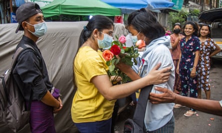 An anti-coup student protester is welcomed home with flowers by the residents of her neighbourhood after being released from jail in Yangon.