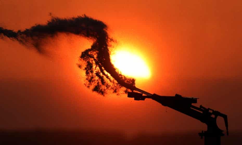 A field of potatoes being irrigated at sunset as a heatwave hits Europe, in Aubencheul-au-Bac, France.