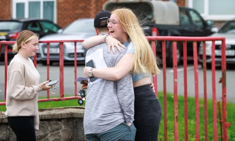 Students at Ysgol Syr Hugh Owen school in Wales react to they receive their A-level results.