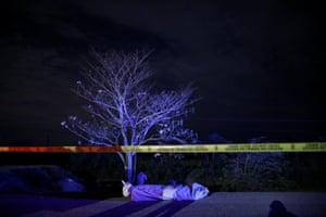 The body of a man lies on a highway in San Pedro Sula