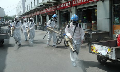Volunteers disinfect the Yuegezhuang wholesale market in Beijing following new cases of coronavirus in the Chinese capital.