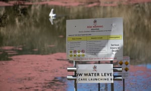 A huge mat of red duckweed floats on the surface of the Macquarie River due to the decreased flow of water.