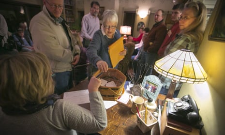 Sharon McNutt hands the ballots to the secretary to be counted at a caucus site Monday, Feb 1, 2016, in Silver City, Iowa. (AP Photo/Dave Weaver)