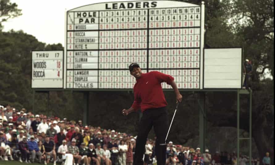 Tiger Woods celebrates his victory after sinking his putt on the 18th at Augusta. He finished 12 shots clear of second place.
