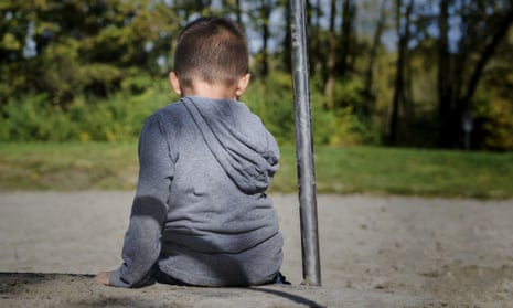 Boy sitting alone in a playground