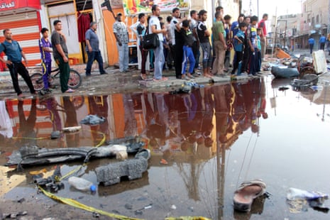 Iraqis gather at the site of a car bomb attack in al-Zobair city in Basra, southern Iraq, October 2015
