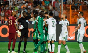 Cameroonian referee Neant Alioum waves away protests after reversing his decision to give Senegal a penalty