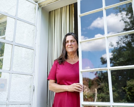 Esther Hyman standing in a doorway leading to a garden