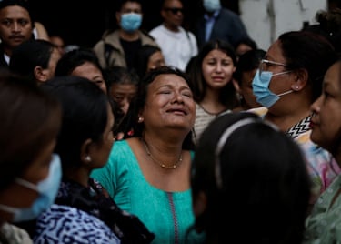 Bina Awale mourns in the middle of a crowd