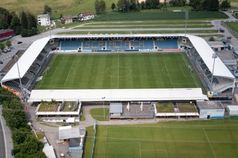 Player in team uniform speaking to media