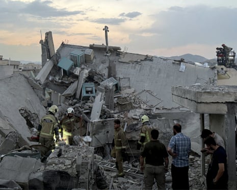 Rescures work in the rubble of a building in Tehran