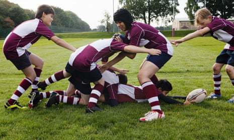 Teenage boys playing rugby