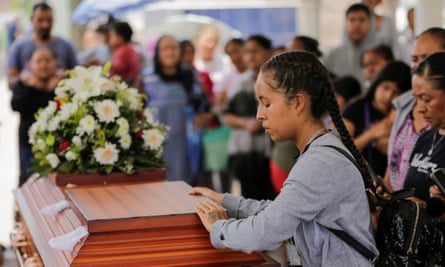 A relative holds a minute of silence during the funeral of Teresa Magueyal, 65, a member of the missing persons search group ‘A Promise to Keep’.
