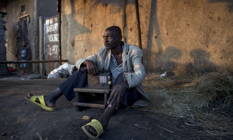 A man listens to the news on the radio in Bujumbura, following the contested presidential election