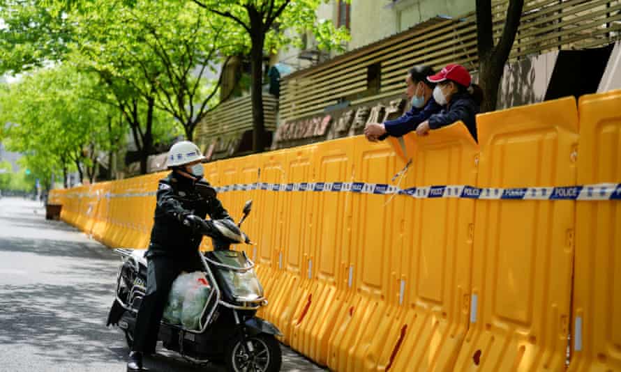 people chat across a covid barrier in shanghai