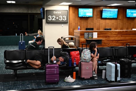 Passengers try to rest and sleep while waiting for delayed and canceled flights off the island.