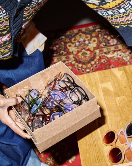 Young adult Black man sorting sunglasses