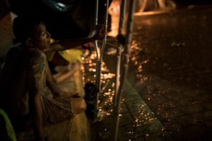 A man seeks refuge from the rain.