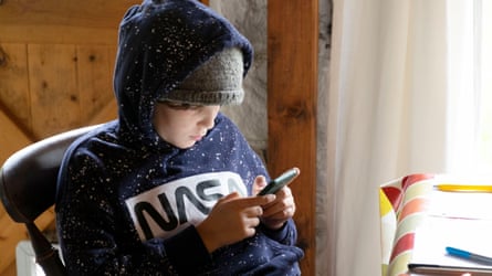 Young person in hoodie on phone