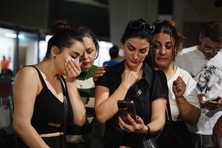 Supporters of the Iranian players wait for news at Sydney airport on Tuesday night.