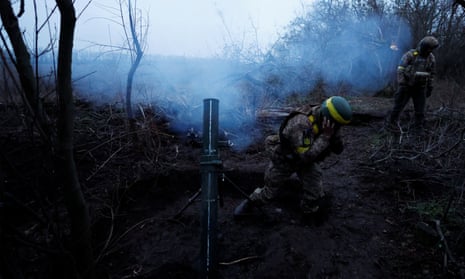 Ukrainian troops fire a mortar round towards Russian positions in the Donetsk region