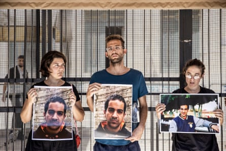 People hold photographs of Eyad al-Hallaq