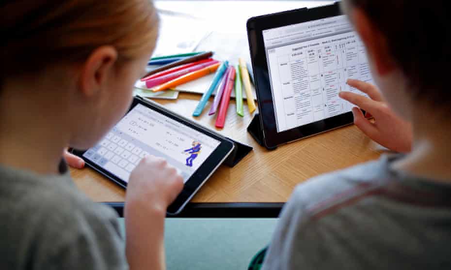 Children doing schoolwork online.
