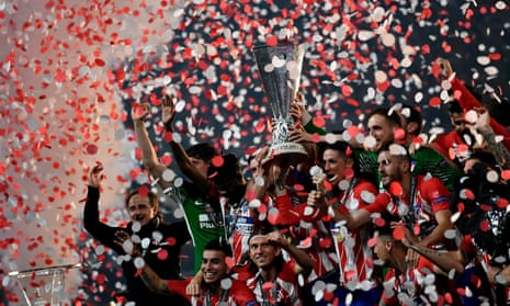 Atletico’s players celebrate with the trophy.