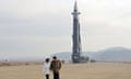 North Korean leader Kim Jong Un walks away from an intercontinental ballistic missile (ICBM) with his daughter.